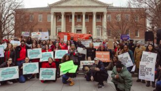 Group photo of rally attendees at Keep the Door Open rally in February 2026.