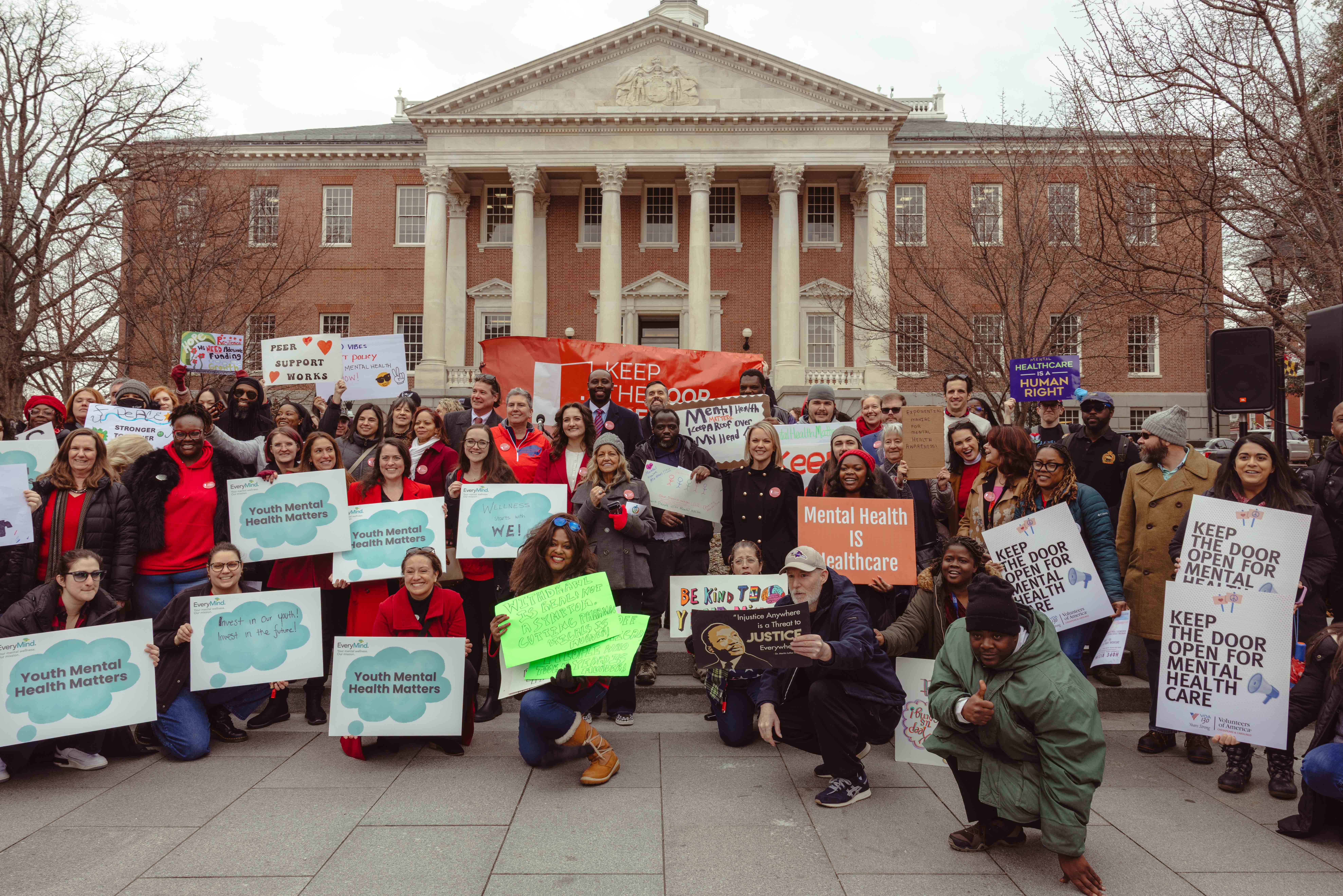 Group photo of rally attendees at Keep the Door Open rally in February 2026.
